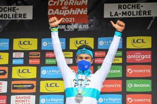 Stage winner Team Astanas Alexey Lutsenko of Kazakhstan celebrates on the podium after winning the fourth stage of the 73rd edition of the Criterium du Dauphine cycling race a 16km time trial between Firmigny and RochelaMoliere on June 2 2021 Photo by Alain JOCARD AFP Photo by ALAIN JOCARDAFP via Getty Images
