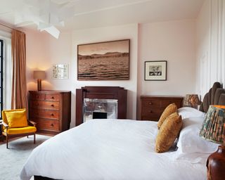 Bedroom with a wall panelling design that reaches over the ceiling and retro fireplace
