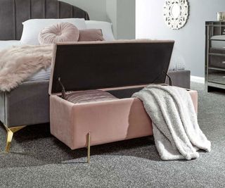 pink padded ottoman in bedroom