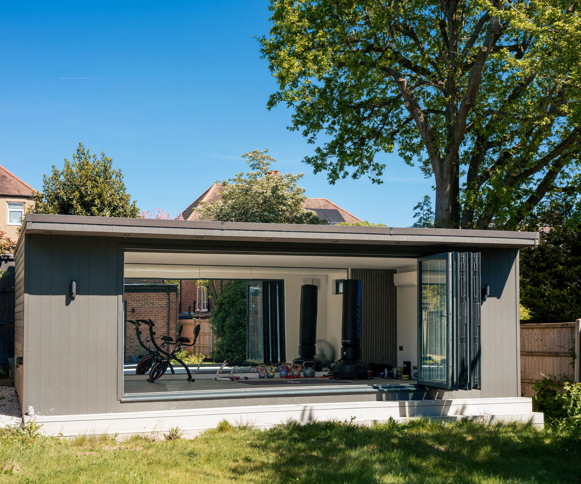 modern garden room building at the end of a garden and fitted out as a home gym space