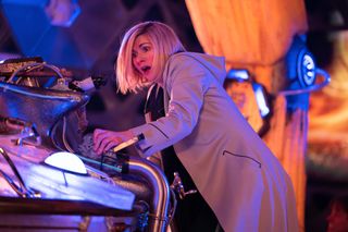 The Doctor (Jodie Whittaker) at the helm of a damaged-looking Tardis, an expression of alarm on her face