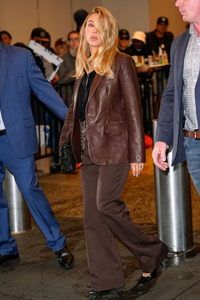 Scarlett Johansson wearing a brown leather jacket and brown pants