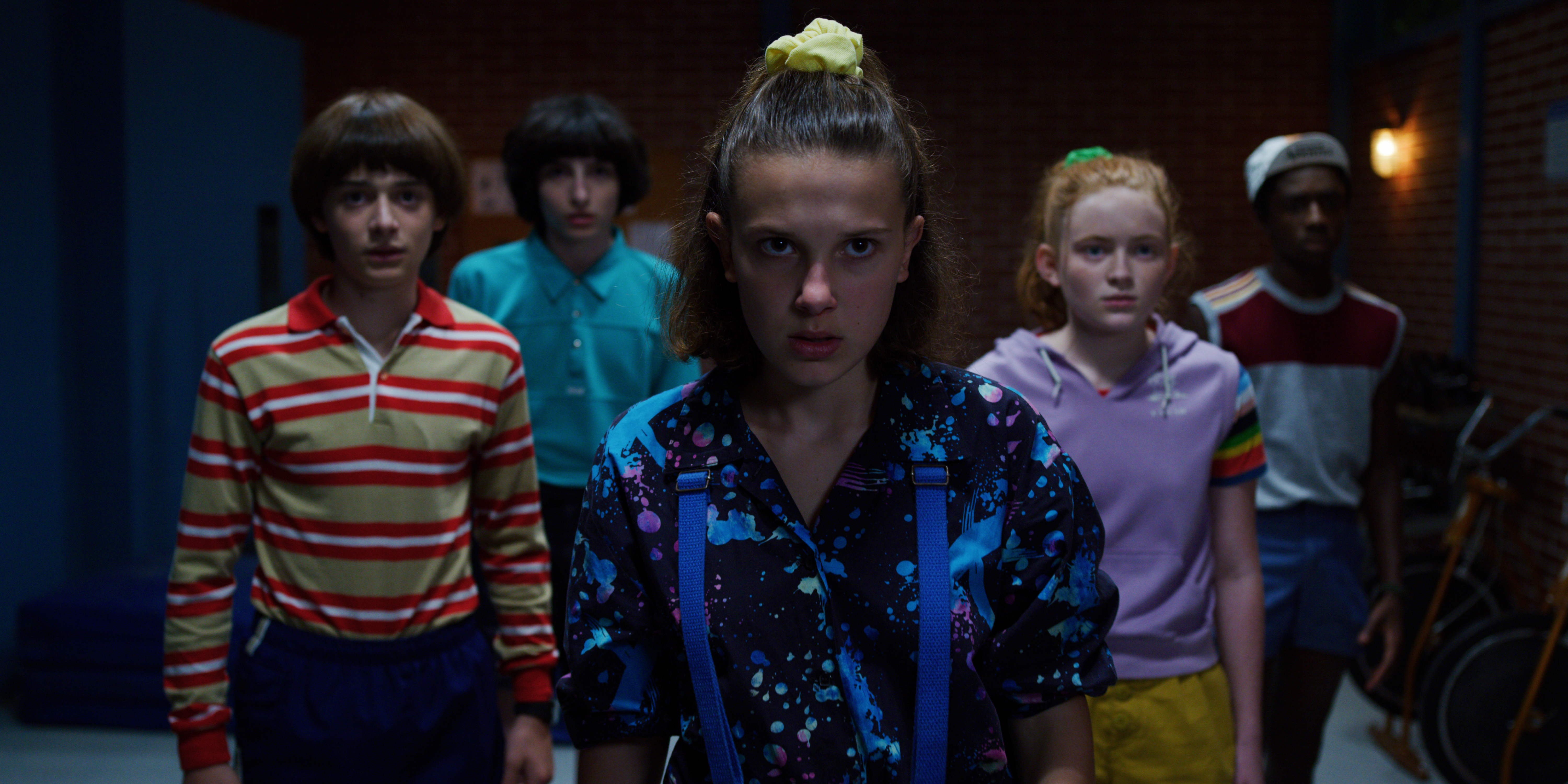 Noah Schnapp, Finn Wolfhard, Millie Bobby Brown, Sadie Sink and Caleb McLaughlin in a darkened corridor