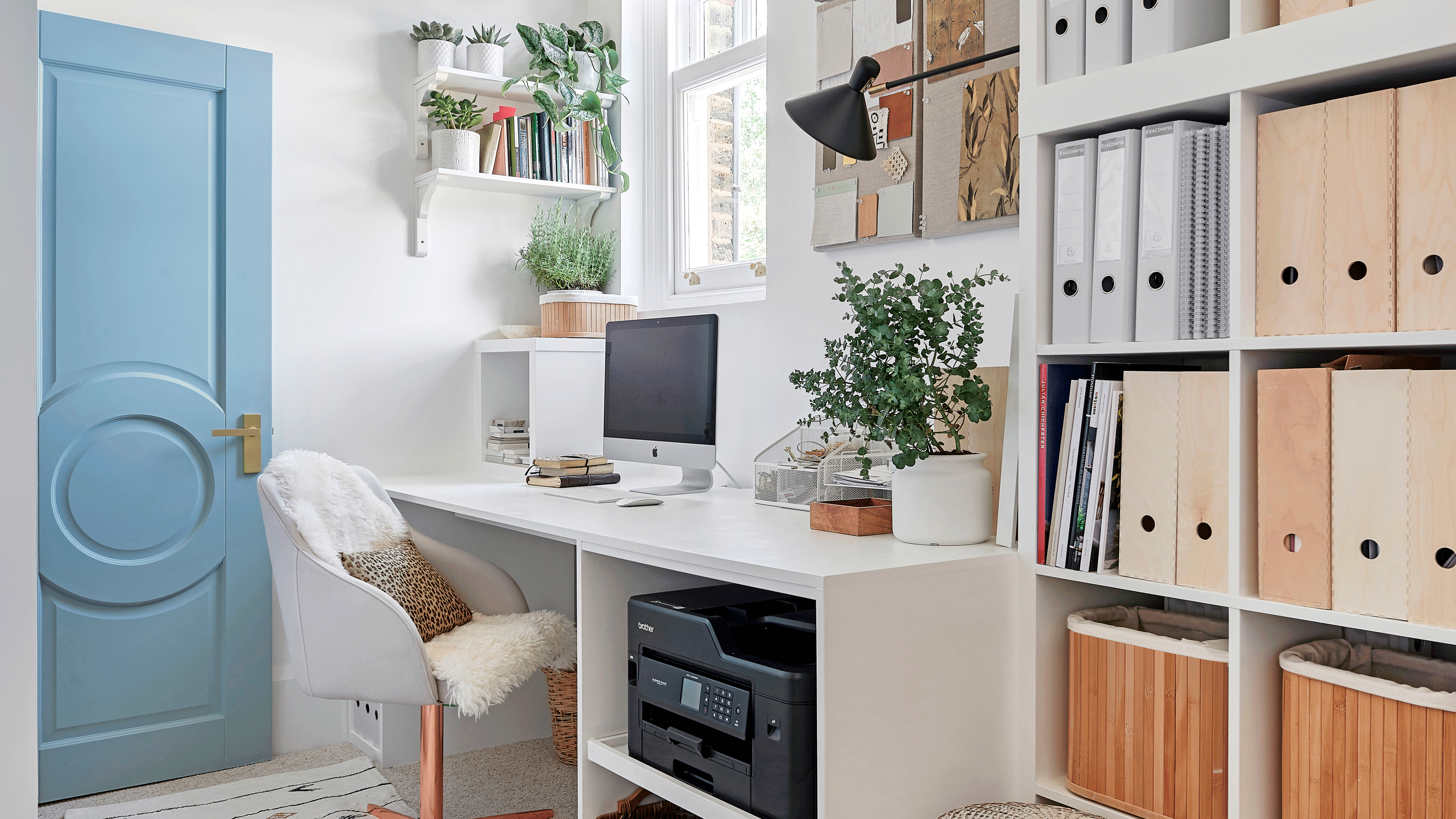 A desk built into a blue-painted home library