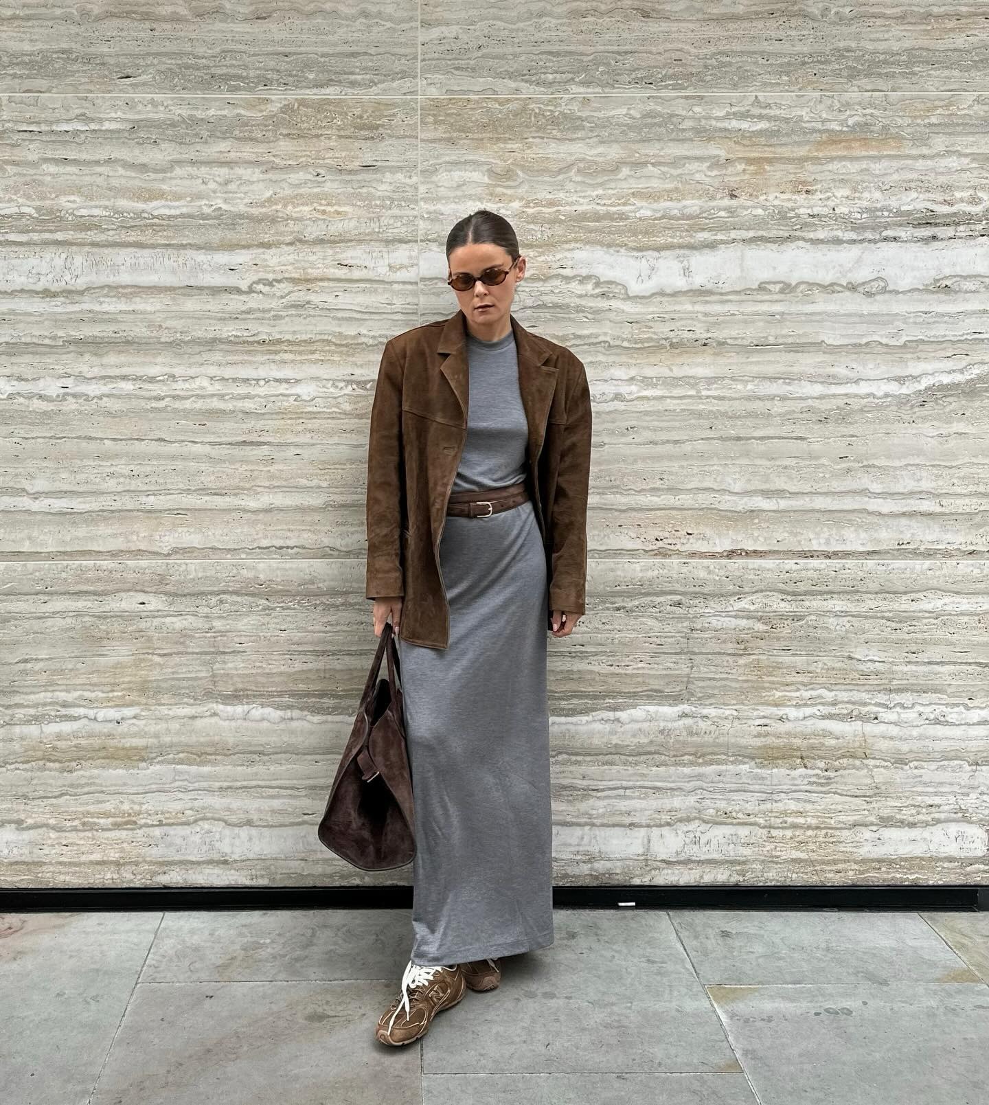 Influencer @rikkekrefting wears a grey skirt and top with a brown suede blazer and brown suede trainers and bag.