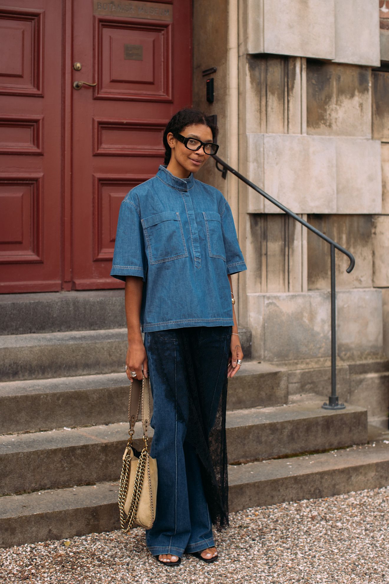 Woman in denim shirt, jeans, and lace dress