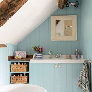 attic bathroom with blue panelled wall