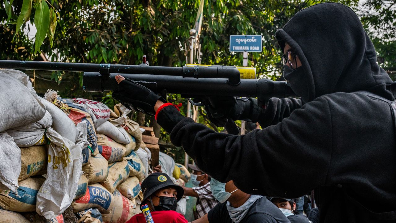 An anti-coup protestor aims an improvised weapon in Yangon, Myanmar