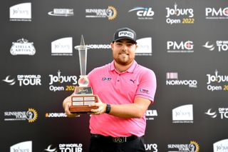 Dan Bradbury poses with the trophy of the Joburg Open after his maiden victory.