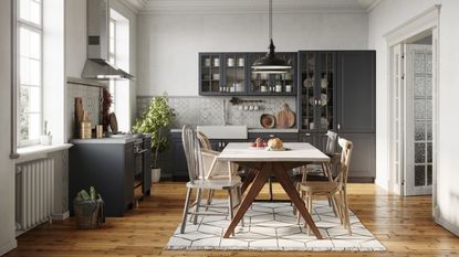 Dining table with area rug in kitchen with blue cabinets