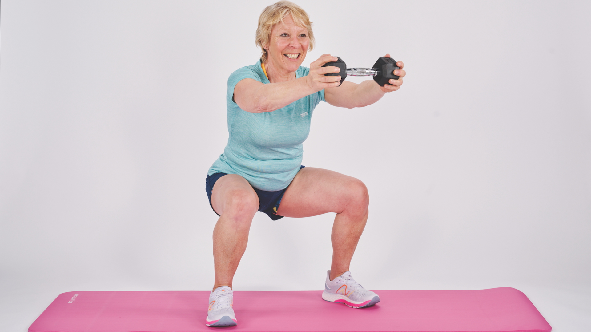 Annie Deadman demonstrating a Squat with front raise with a dumbbell