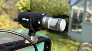 A close-up off the Shure MoveMic 88+ showing a big R (for right) written on its side so that you know it’s mounted the right way up