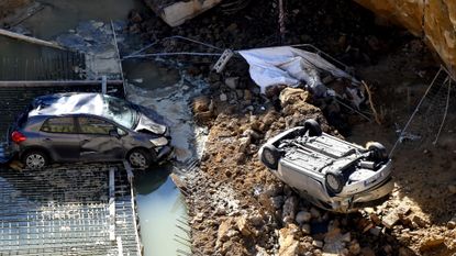 A sinkhole swallows cars in Rome in 2018