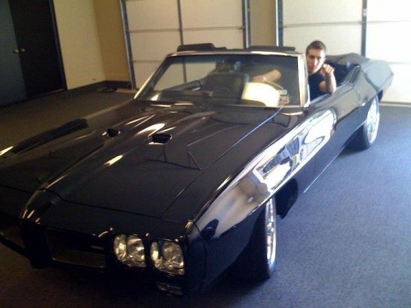 Armstrong's Pontiac GTO convertible and one spoiled kid in the driver's seat!