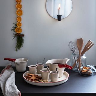 dinnerware with white wall and hot chocolate in glasses
