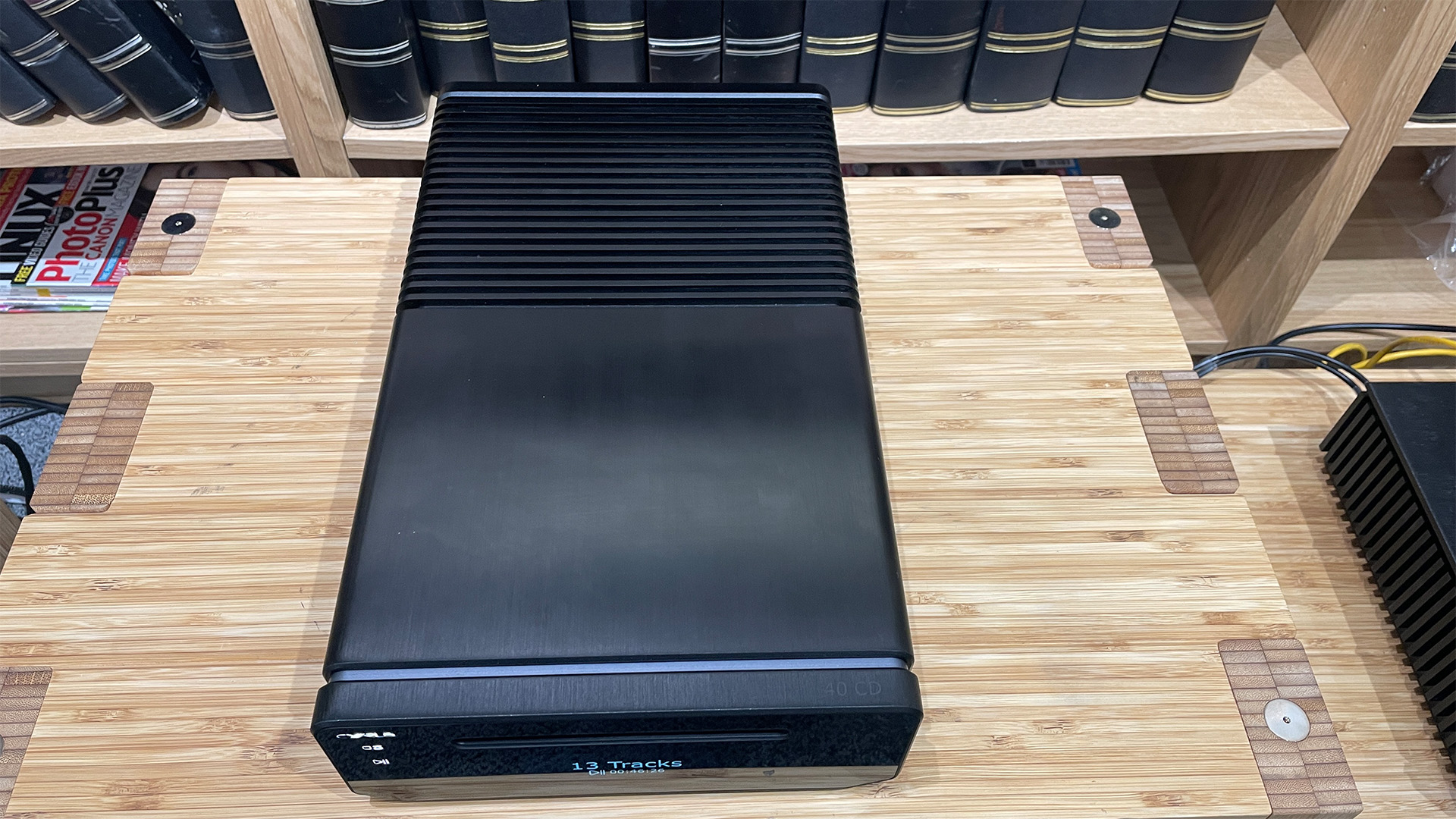 Cyrus 40 CD CD player on wooden hi-fi rack in front of bookcase top down view
