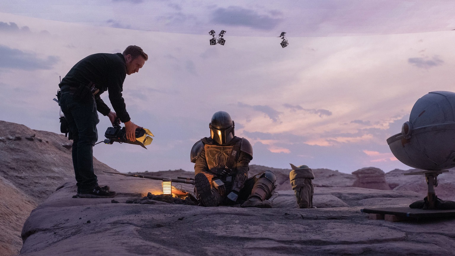 A behind the scenes photo of Grogu and Din Djarin filming The Mandalorian in The Volume set