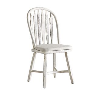 Loaf Bossy dining chair with distressed white paint and a white cushion.