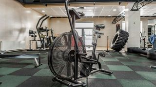 An air bike shown inside an empty gym