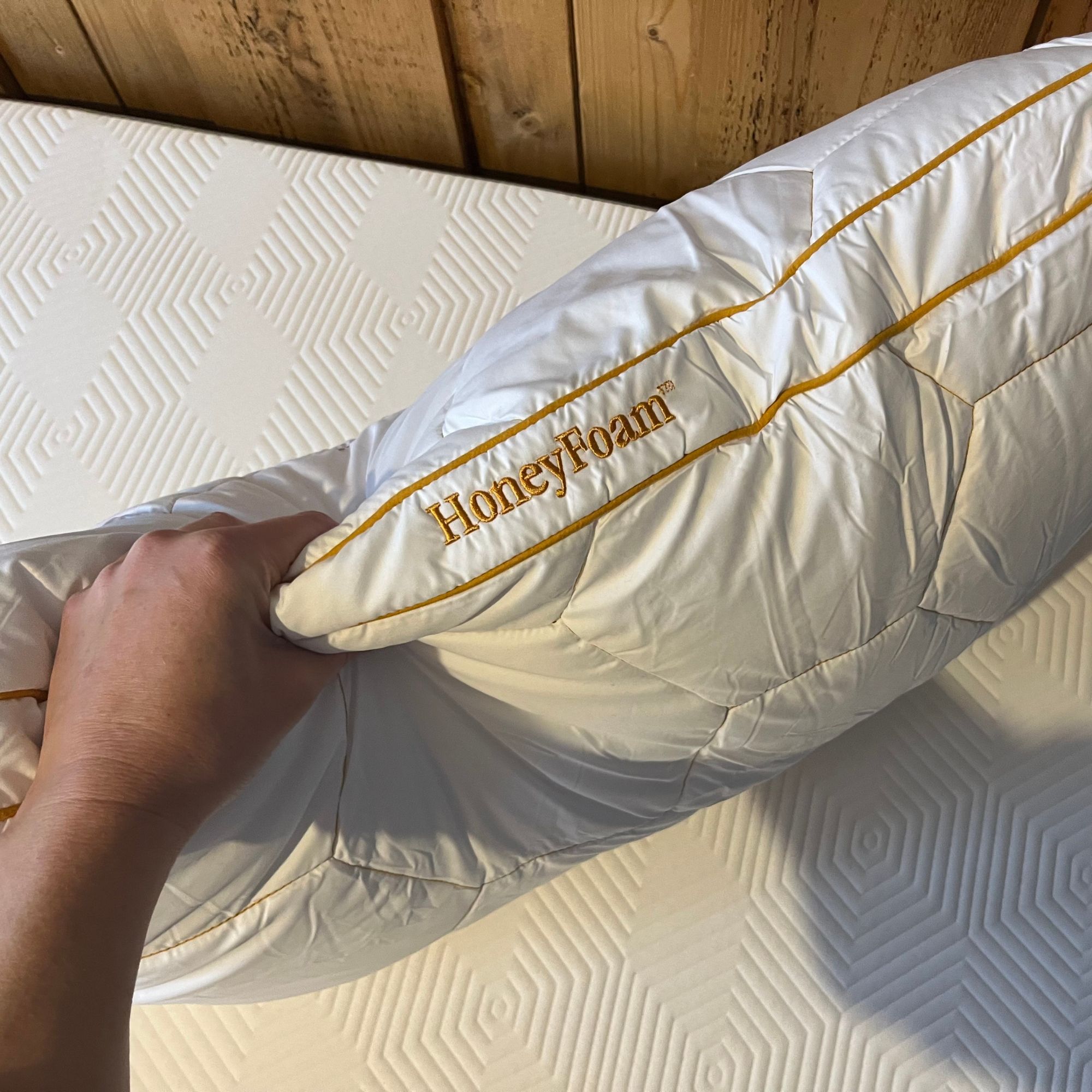 HoneyFoam pillow squish test with hand