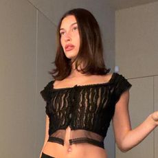 Hailey bieber wears a black cropped going-out top.