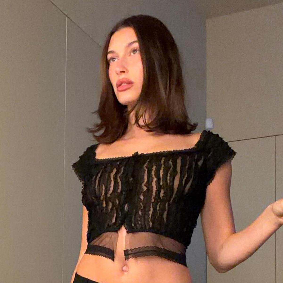 Hailey bieber wears a black cropped going-out top.