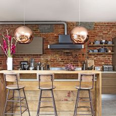 kitchen room with exposed brick walls and kitchen shelves 