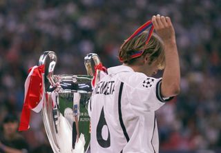 Valencia midfielder Gaizka Mendieta passes by the Champions League trophy after losing the 2001 final to Bayern Munich.