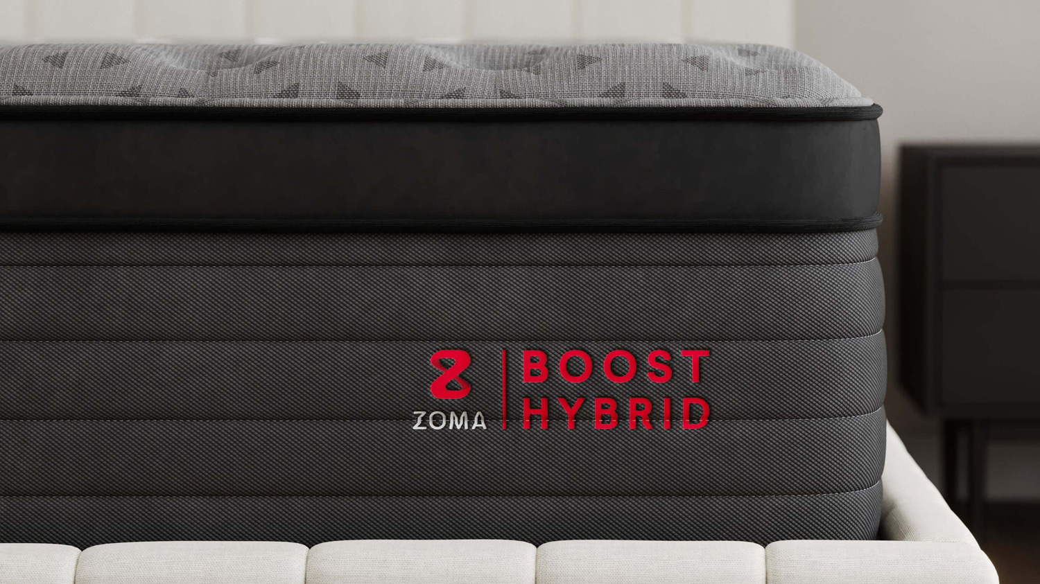 The edge of the Zoma Boost mattress, showing the logo