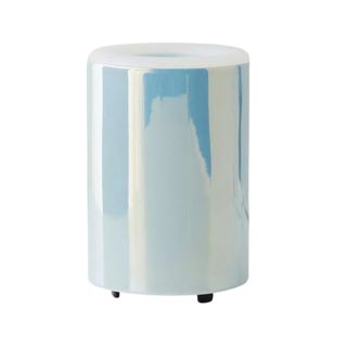 A small, light blue iridescent cylindrical wax melter with small black legs