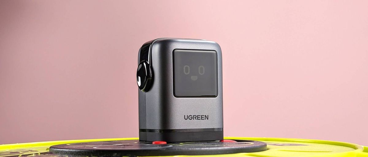 UGreen Uno Charger 100W plugged in with smiling emotion on display