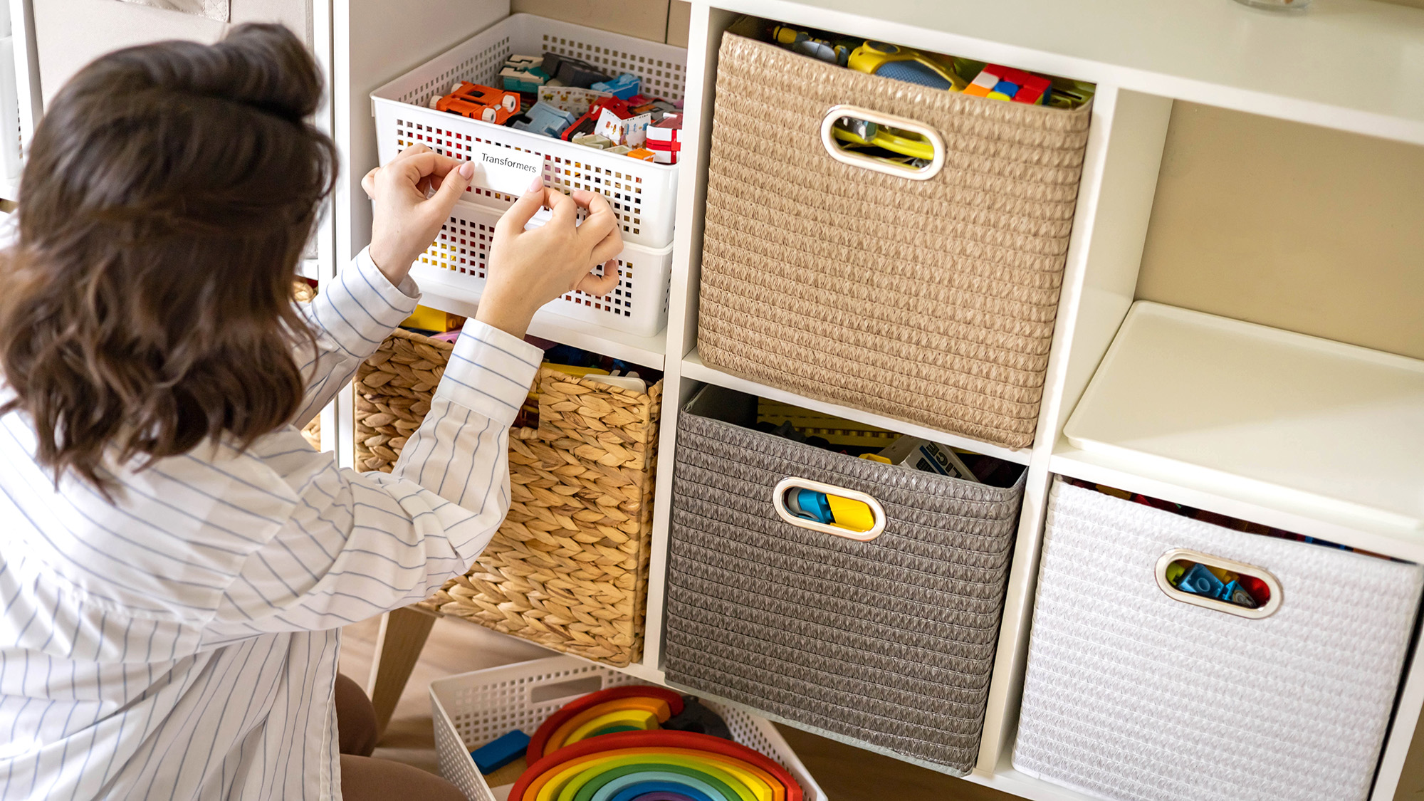 Woman adding labels to toy boxes
