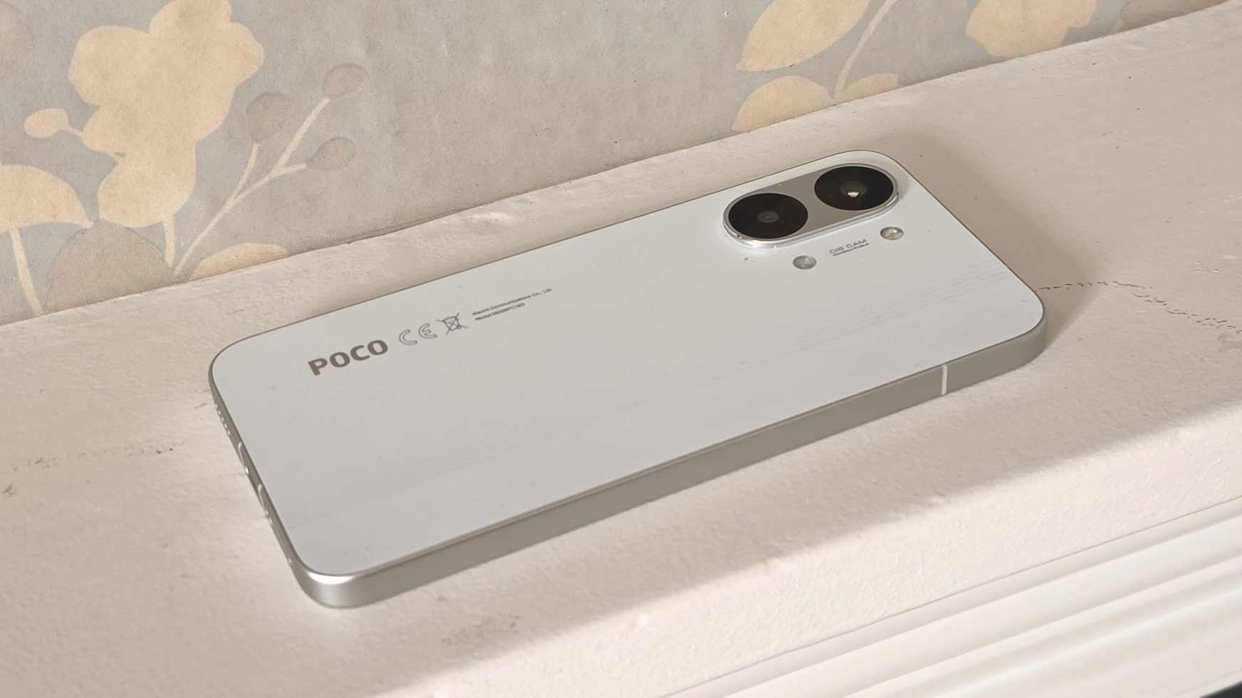 The Poco X8 Pro Max laying flat on a ledge, showing its rear.