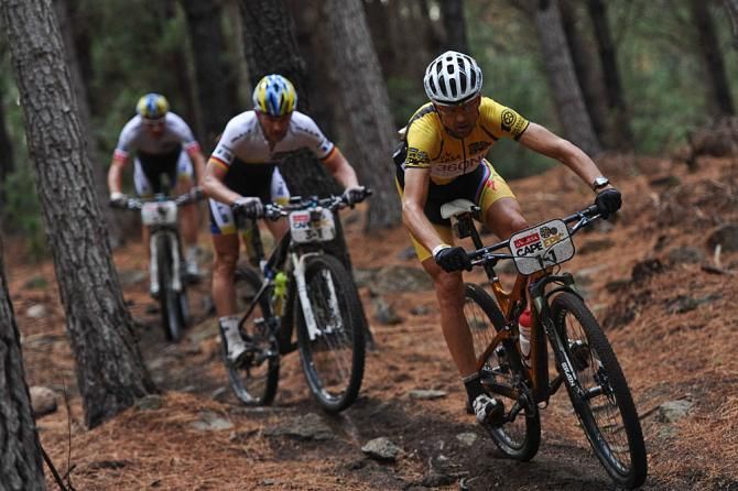 Overall race leader Christoph Sauser of Tam Burry Stander - Songo is chased by second place Team Bulls