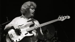 Donald 'Duck' Dunn performs on stage with Eric Clapton at Ahoy, Rotterdam, Netherlands, 23rd April 1983. He plays a Fender Precision bass guitar.