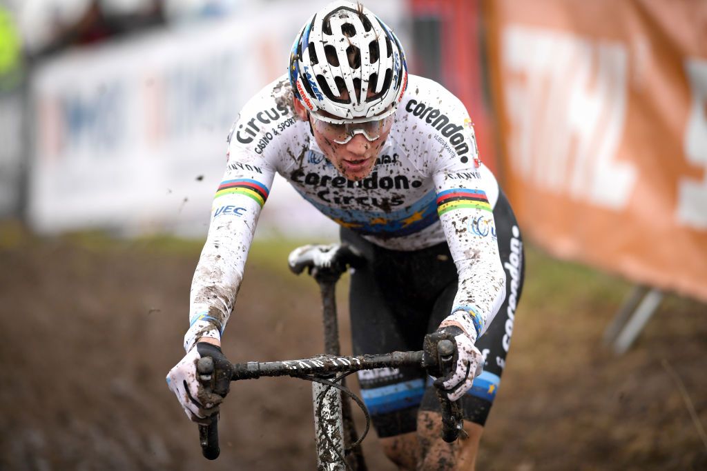 Mathieu van der Poel runs through the mud