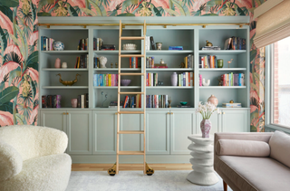 A home office with storage painted green