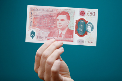 A hand holding up the new £50 note