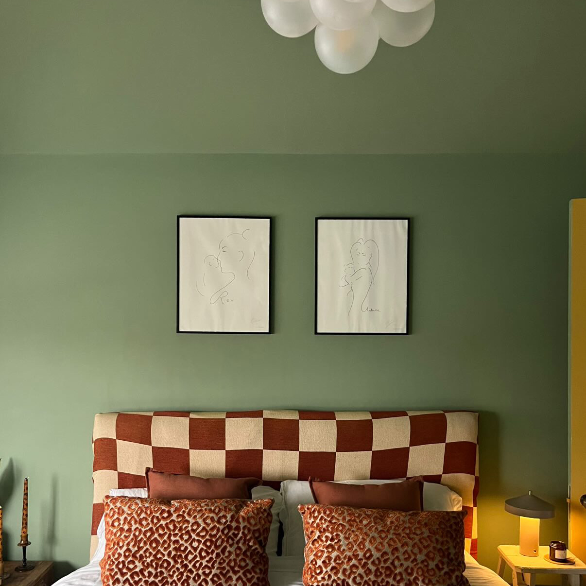 green bedroom with red check headboard