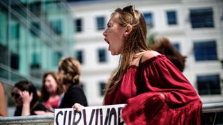 Meghan Downey of Chatham, New Jersey protests outside as U.S. Education Secretary Betsy DeVos announces changes in federal policy on rules for investigating sexual assault reports on college campuses in Arlington, Virginia...