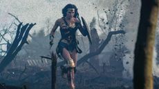 Gal Gadot running across a battlefield in Wonder Woman