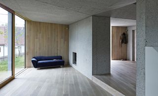 Gray wood floors with a navy sofa