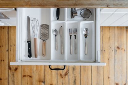 cutlery in cutlery organizer in kitchen drawer