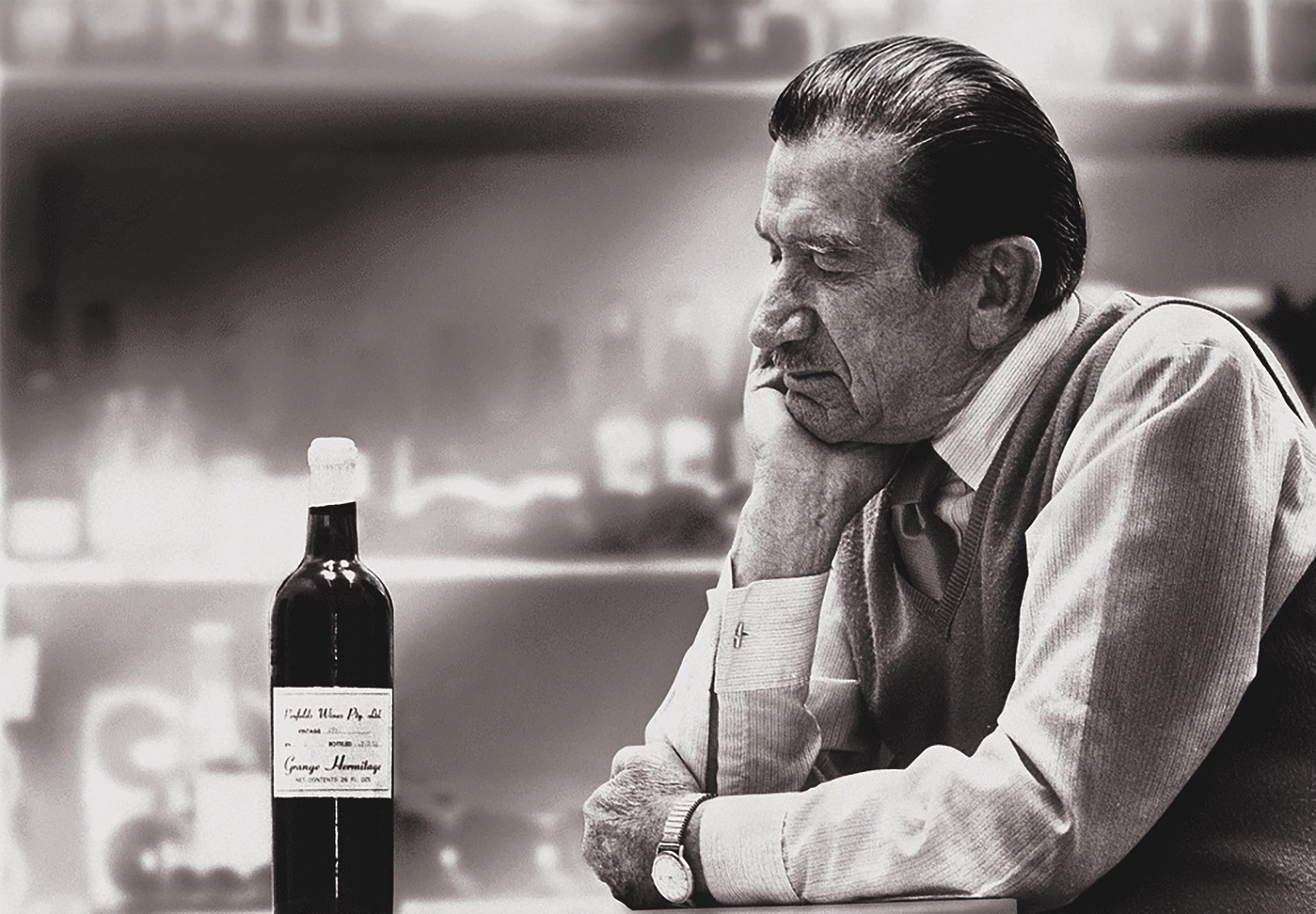 Max Schubert looking at a bottle of Grange