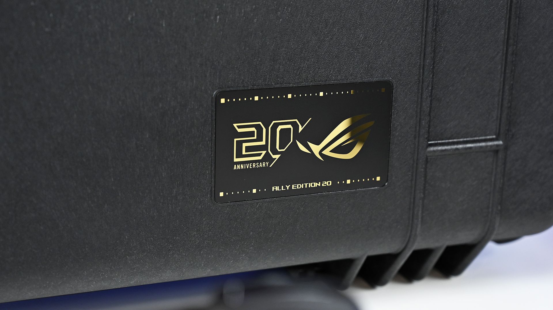 Close-up of the Pelican case's gold 20th Anniversary ROG badge, reading