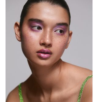 A model wearing purple shimmery eyeshadow