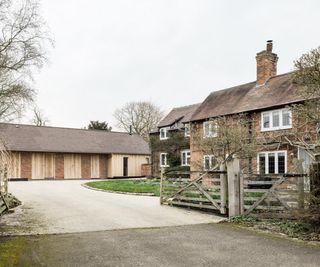 before and after images of garage block converted into an extended annexe with larch gladding and pitched roof