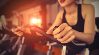 Are exercise bikes good cardio? Image of woman using exercise bike