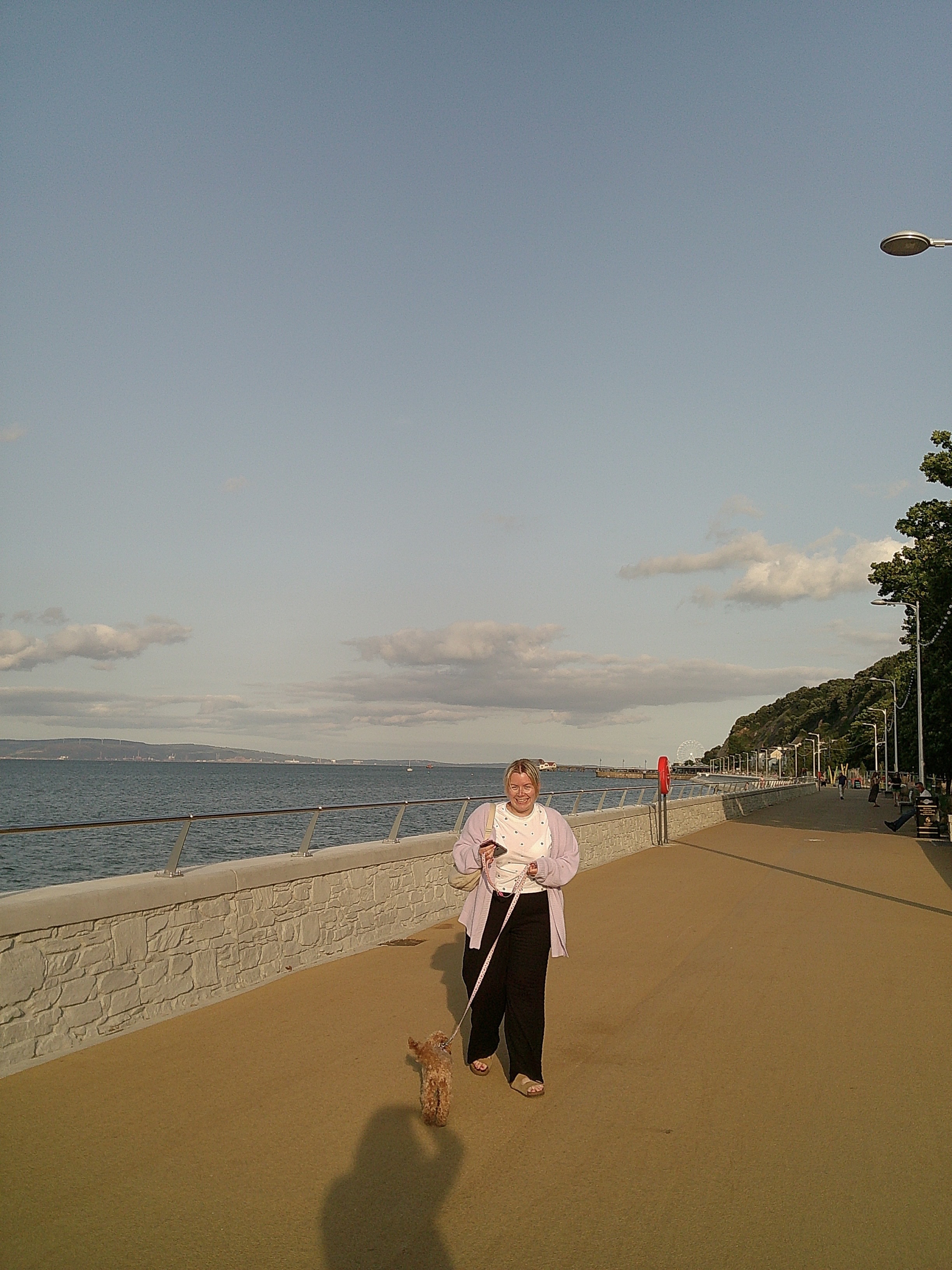 Image of a woman walking a dog taken with the Camp Snap Screen-Free Digital Camera. 