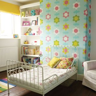 yellow and green bedroom with floral chimney breast